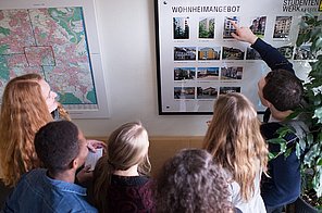 Students looking at the student hall information at Studierendenwerk