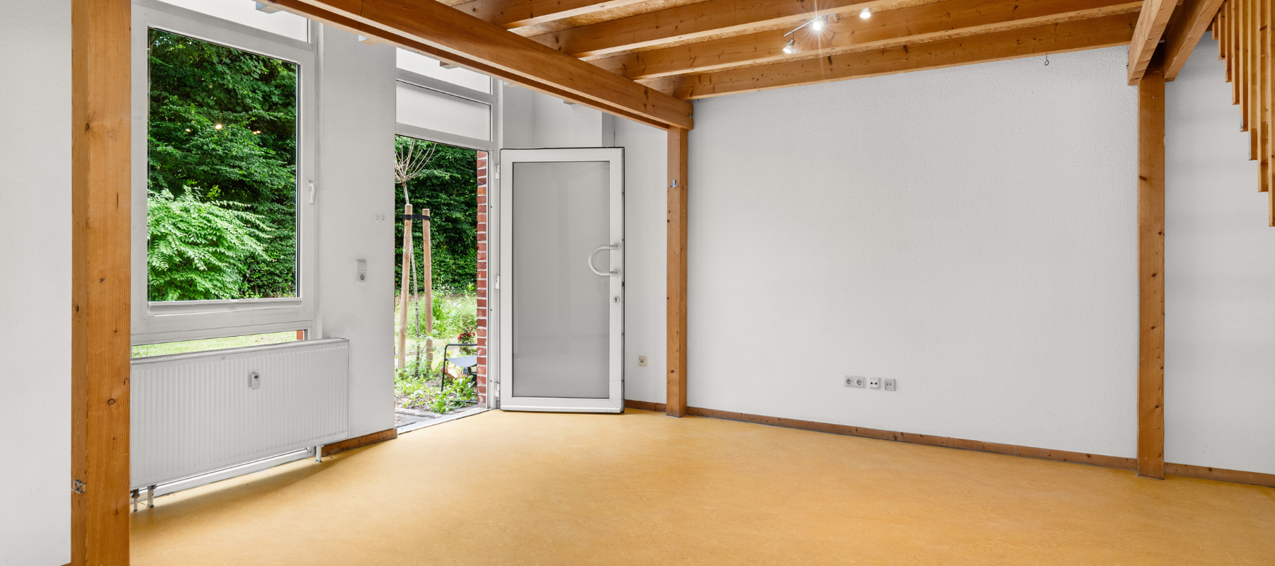 Foto vom Eingangsbereich der Studio-Wohnung. Zu sehen ist ein großer, offener Raum ohne Möbel.